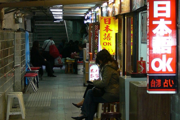 Women sitting outside of shops in Japan